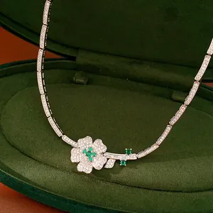 Close-up detail of a vintage style necklace with green zircon flower in a green velvet box