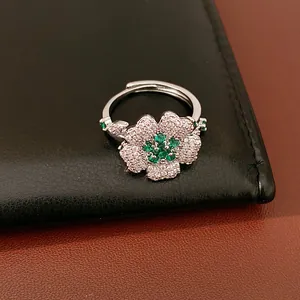 Detailed shot of a luxury adjustable silver ring with green zircon flower centerpiece