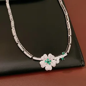 Exquisite close-up detail of the floral pendant necklace featuring green and white zircons