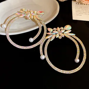 Detailed close-up view of vintage iridescent rhinestone flower hoop earrings with pearls