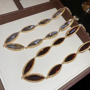 Macro view of luxurious marquise-cut amber and grey gemstones in gold-textured frames
