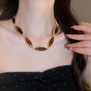 Detailed view of luxury marquise amber stone necklace with gold-tone setting on neck