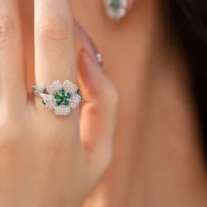 Macro view of an elegant flower-shaped ring with pavé-set green and white zircon stones