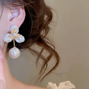 Detailed macro shot of elegant French vintage flower petal stud earrings with pearl