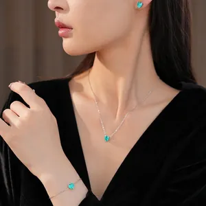 Elegant jewelry set with green heart zircon pendant necklace and matching bracelet.