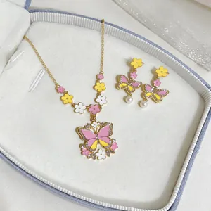 Detailed view of enamel butterfly and flower necklace and earring jewelry set