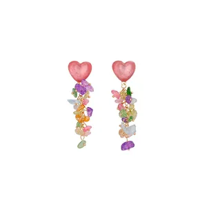 Exaggerated colorful heart earrings with vibrant crushed stone tassels in island style.