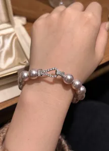 Macro view of elegant pearl bracelet featuring a sparkling zircon pave buckle clasp