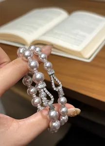 Close-up detail of a vintage French-style pearl bracelet with a sparkling zircon buckle