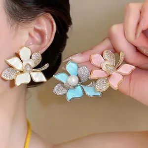 Elegant 18K gold plated flower earrings with sparkling zircons and pearl center.