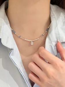 Elegant pearl beaded necklace featuring blue crystals and a rectangular zircon pendant