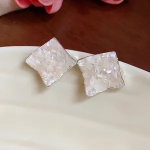 Elegant silver needle stud earrings with crushed mother-of-pearl and wrinkled rhombus design