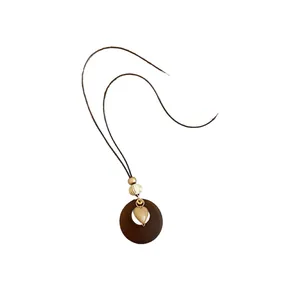 Ethnic style brown resin round necklace with heart pendant on long cord
