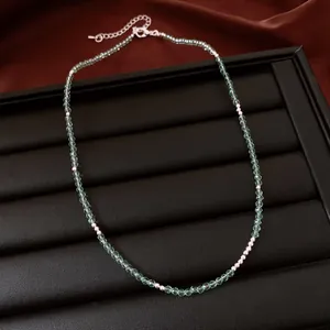 Close-up of elegant handmade green zircon beaded necklace for layering on jewelry display