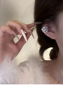 Close-up detail of a sparkling micro-set crystal ear cuff jewelry worn on the ear bone