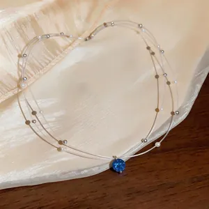 Elegant double-layer choker necklace featuring a blue zircon pendant and pearl beads