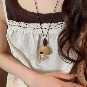 Detail of Bohemian retro necklace with wooden moon pendant and hanging beads on model