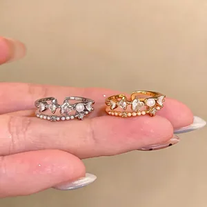 Elegant open ring set with zircon heart, pearls and starburst details in gold and silver finish