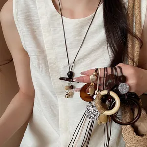 Bohemian retro wooden heart and circle long sweater chains on a model wearing white sleeveless top
