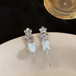 Elegant long tassel earrings featuring zircon flowers and white resin petal details