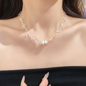 Close-up of an elegant pearl and crystal beaded necklace on a female model's neck