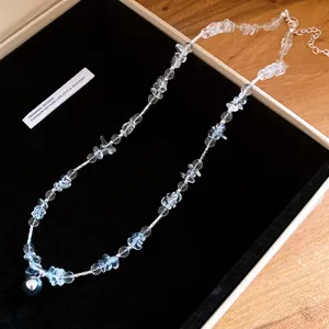 Elegant crystal beaded necklace with pearl pendant displayed in a luxury jewelry box