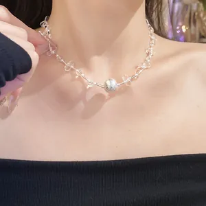 Close-up detail of a crystal beaded necklace with a frosted silver bead.