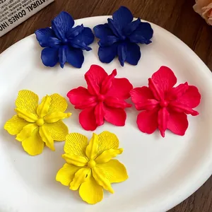Bohemian style matte painted floral stud earrings in vibrant blue, pink, and yellow colors