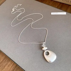 Elegant silver-toned necklace with minimalist hollow teardrop pendant jewelry detail