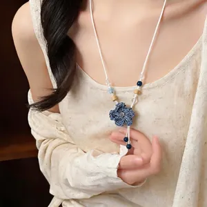 Elegant handmade woven blue flower necklace with natural wooden and ceramic beads