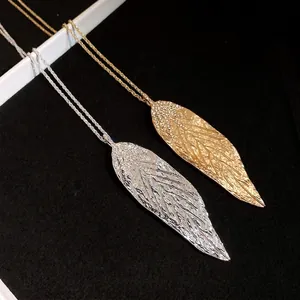 Elegant gold and silver leaf pendant necklaces featuring sparkling crystal pavé details