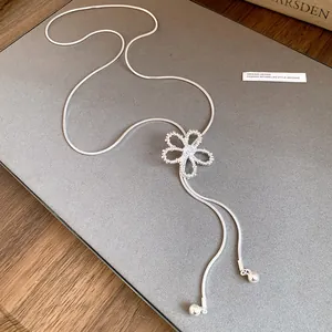 Detail view of a silver hollow flower necklace with zircon, adjustable chain design.