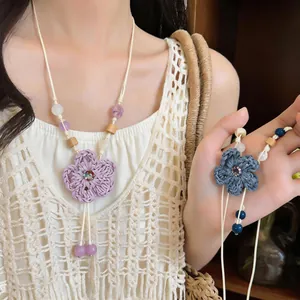 Handcrafted woven flower necklace with wood beads for vacation style boho jewelry design