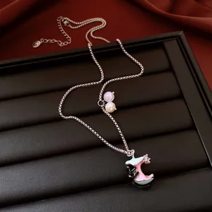 Detail view of cute bitten apple necklace with cat pendant and colorful beads