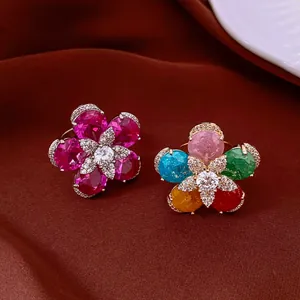 Detail shot of two vibrant 18k gold plated flower rings with colorful zircon stones