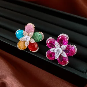 Detail shot of 18k gold plated colorful zircon flower open rings on luxury display