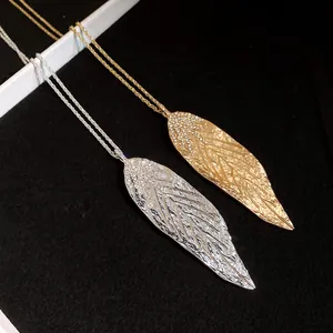 Macro view of textured gold and silver leaf pendants with sparkling rhinestone detail