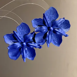 Close-up of matte royal blue flower stud earrings with orchid petal texture