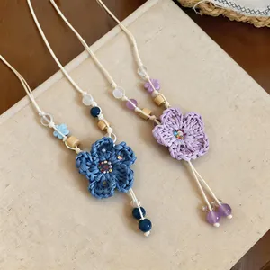 Handmade crochet flower necklace with wooden and ceramic beads in a boho style