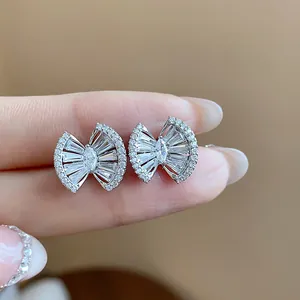 Detailed view of geometric fan earrings with sparkling zirconia in 18k gold plating