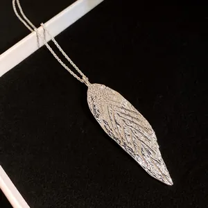 Detailed macro view showing the intricate hammered texture of the silver leaf pendant.
