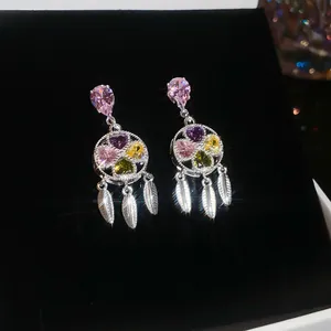 Macro detail of luxury vintage court style earrings with colorful zircons and tassels