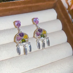 Detailed macro view of vintage court style earrings with colorful heart zircons.