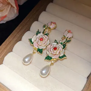 Boucles d'oreilles élégantes en émail rose de style vintage avec perles blanches en goutte.