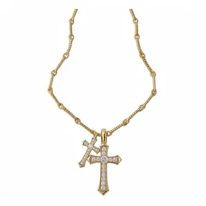 Elegant gold-tone necklace with double cross pendants set with sparkling zircons.
