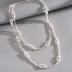 Vue détaillée d'un élégant collier à deux rangs avec perles de verre et billes argentées.