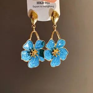 Vintage blue enamel flower dangle earrings with gold finish, elegant floral jewelry