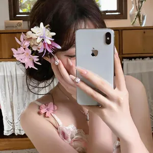 Detailed macro view of a beach-style floral shell hair clip with pearl accents