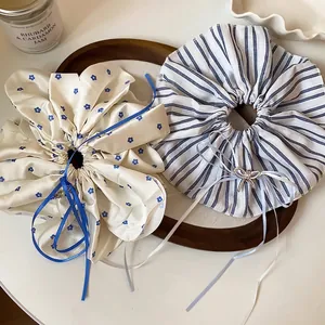 Two large elegant hair scrunchies with floral pattern and classic blue stripes design