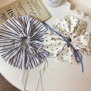 Set of elegant oversized scrunchies with floral and striped patterns and bow charms.